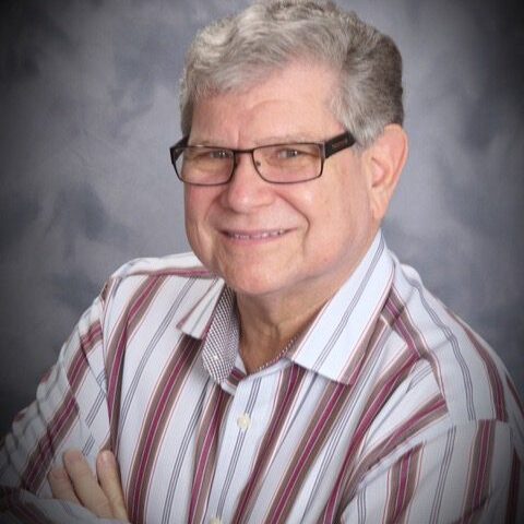 A man with glasses and a striped shirt